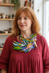 Woman wearing a colorful Bohemian style statement necklace - Handmade from recycled leather