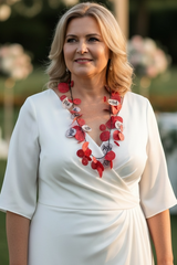 Woman in a white dress with a red necklace handmade from recycled paper by jianhui london at an outdoor event